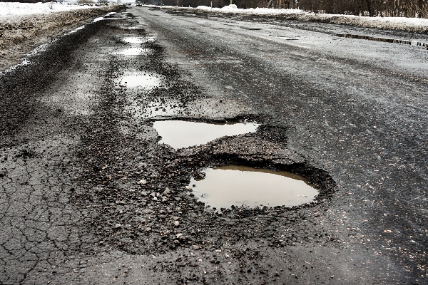Make sure to take care of winter asphalt paving maintenance before the winter cold sets in or you will have potholes like the ones in this picture.